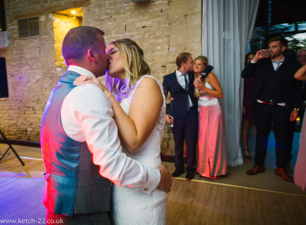 Bride and groom kissing at first dance