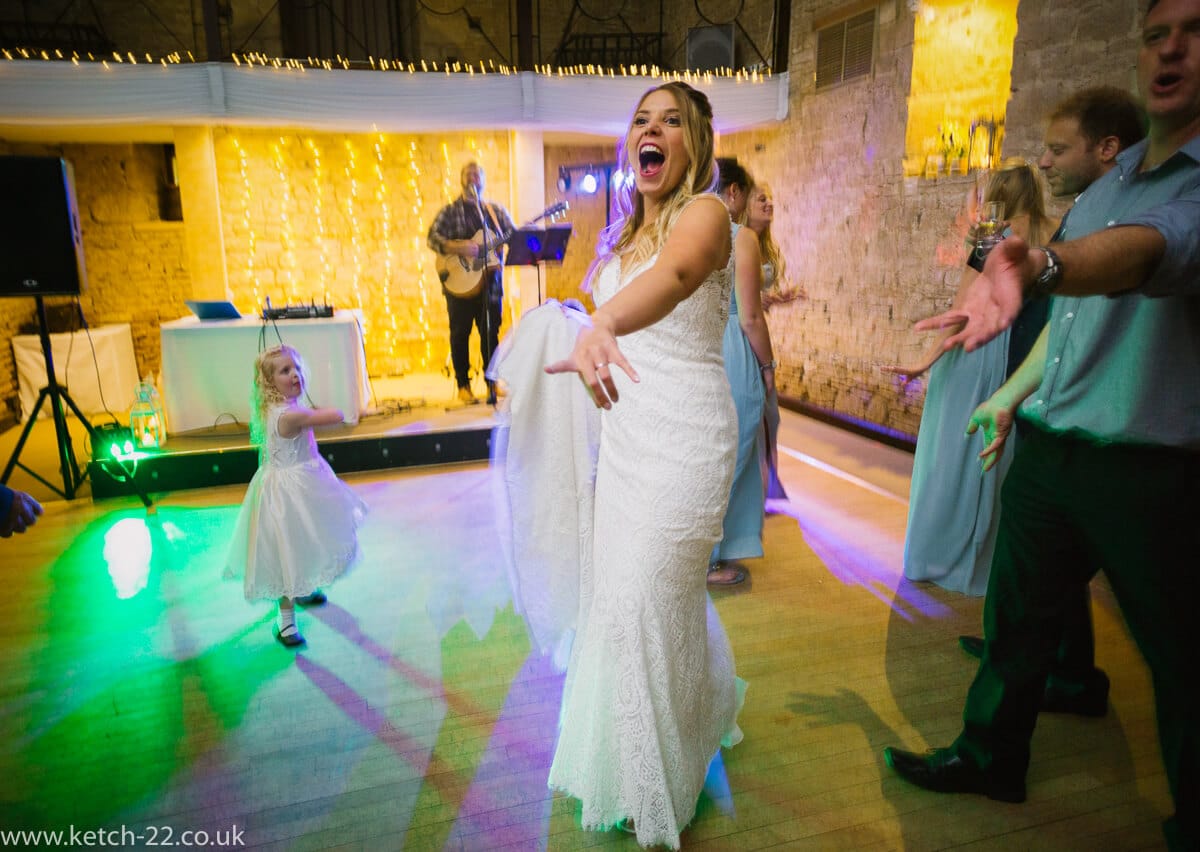 Bride going crazy on dance floor at The great Tythe Barn Wedding