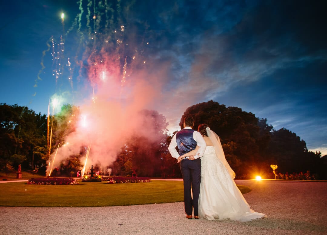 newly weds admire firework display at Clearwell Castle