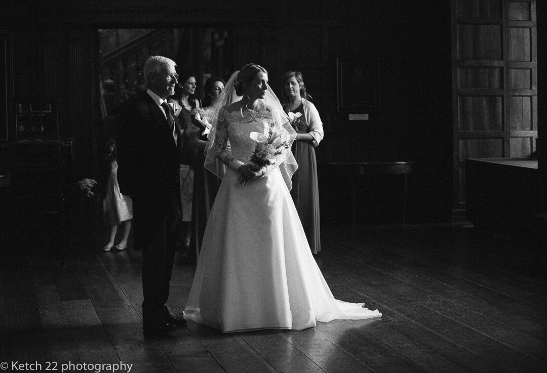 Moody black and white photo of bride just before wedding ceremony