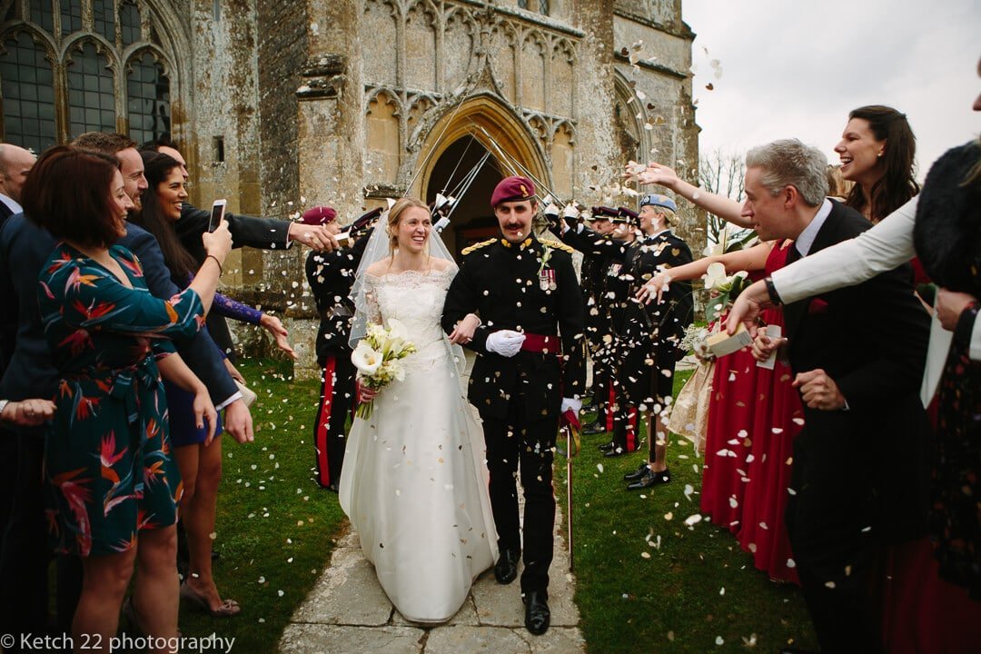 documentary wedding photo of bride and groom getting showered with confetti at Somerset wedding