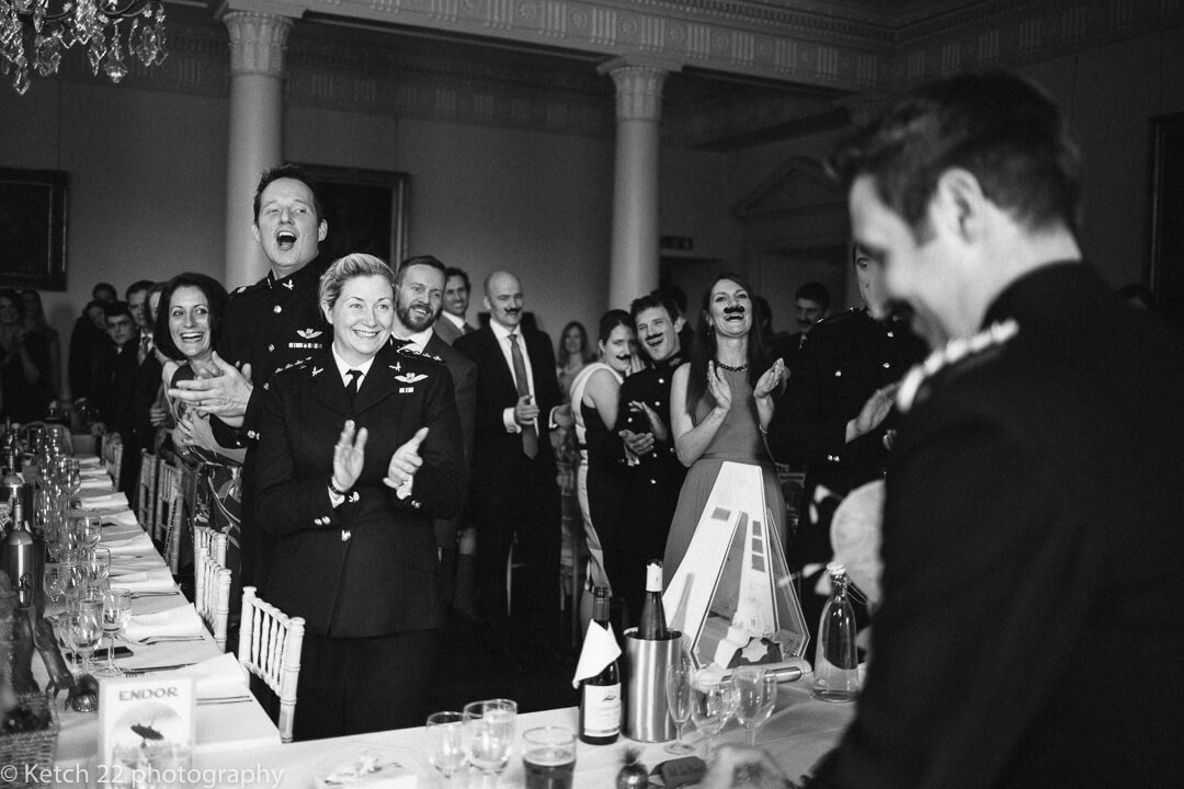 Wedding guests cheering bride and groom at Country house wedding