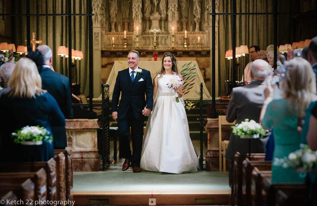 Bride and groom leaving church after wedding ceremony