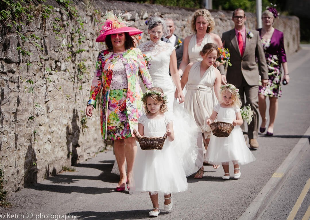 Bridal party walking down road at Hay on Wye wedding