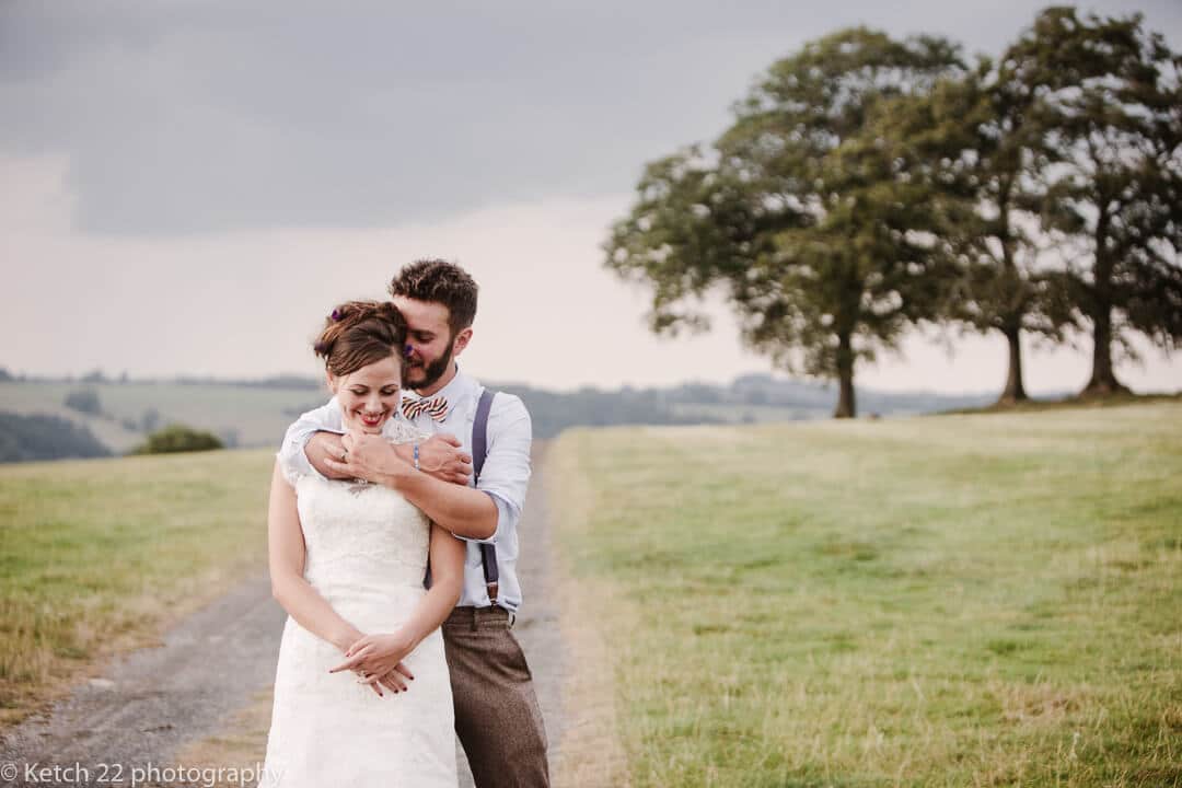 Romantic portrait of bride and groom in rural setting