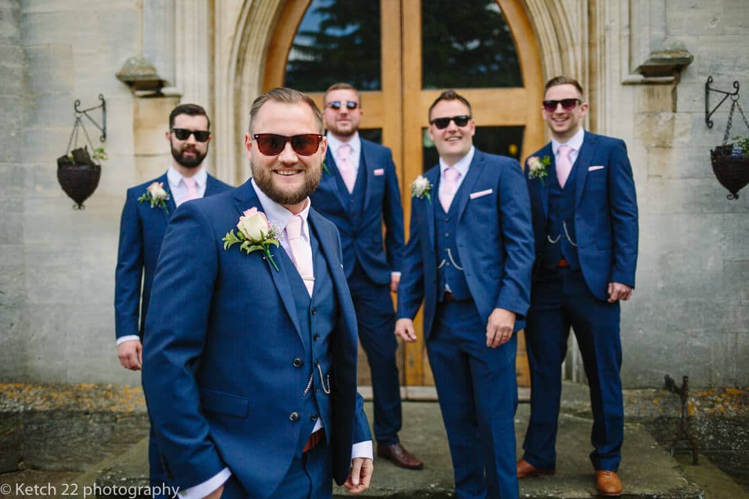 Groom and groomsmen with shades and blue suits at Gloucestershire wedding