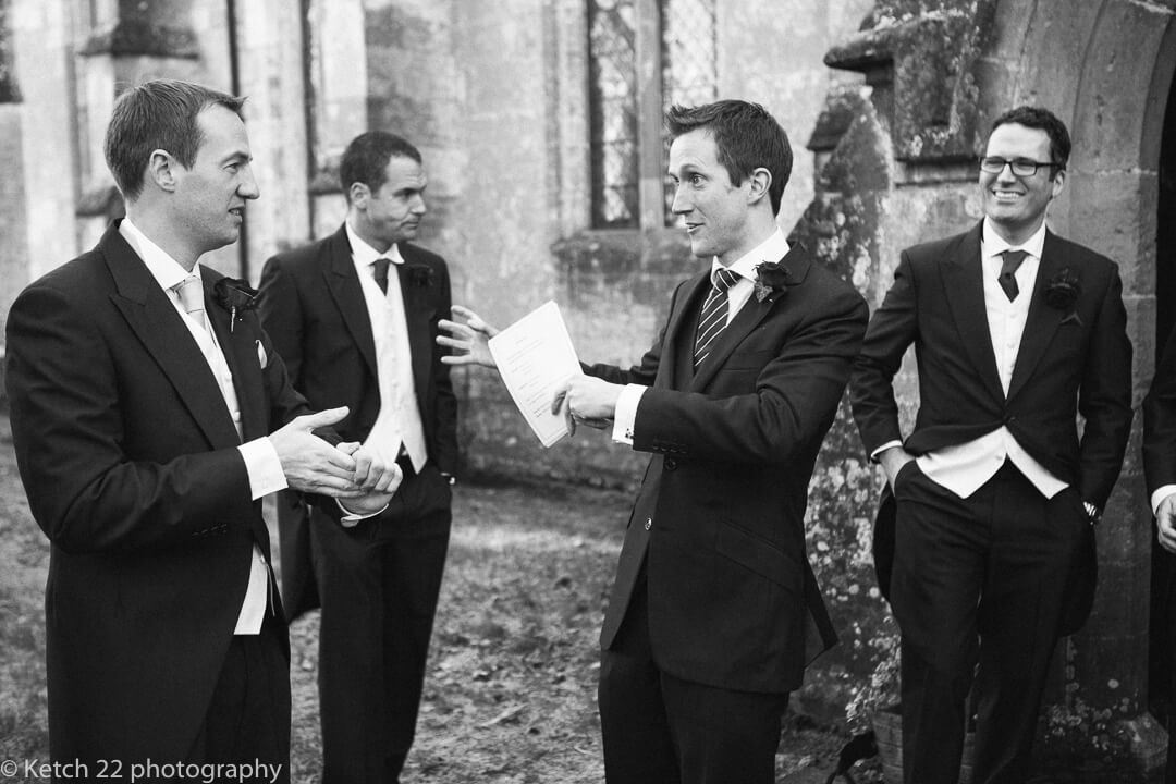 Groom and groomsmen chatting outside church just prior to wedding ceremony