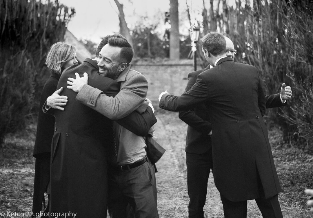 Ushers greeting guests at Winter wedding