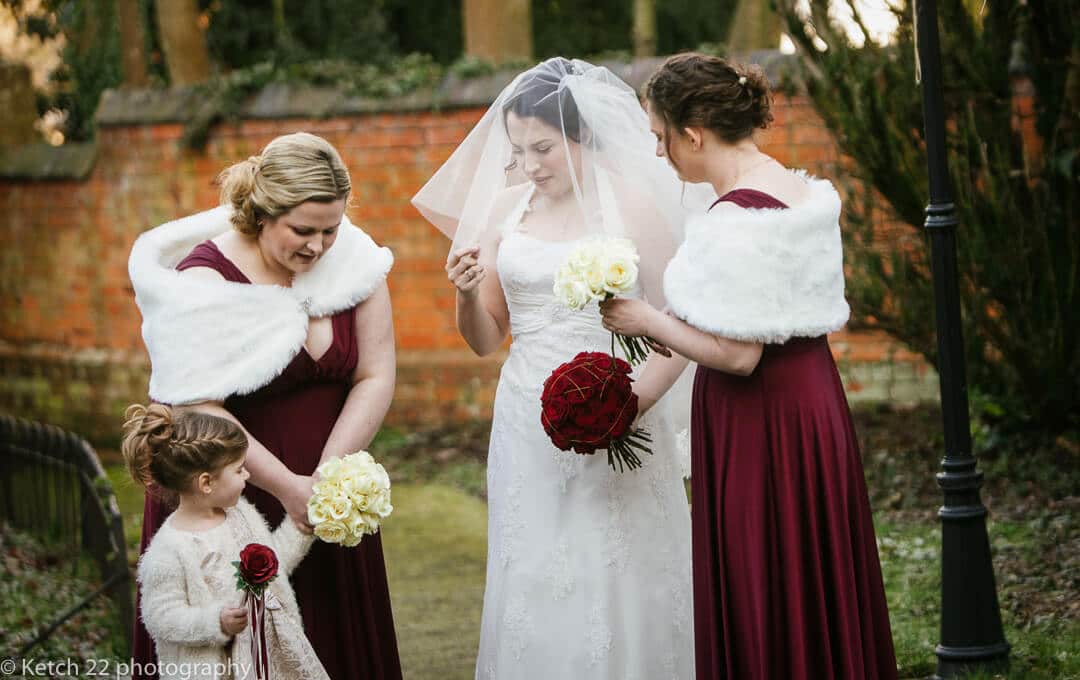 Bride adjusting her wedding veil before ceremony