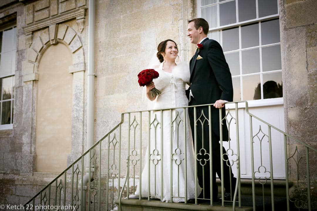 Bride and groom standing at top of steps at Elmore Court wedding