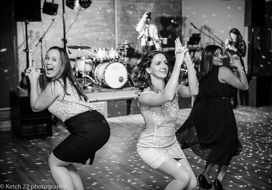 Girls pretending to be Charlies Angels at Elmore Court wedding