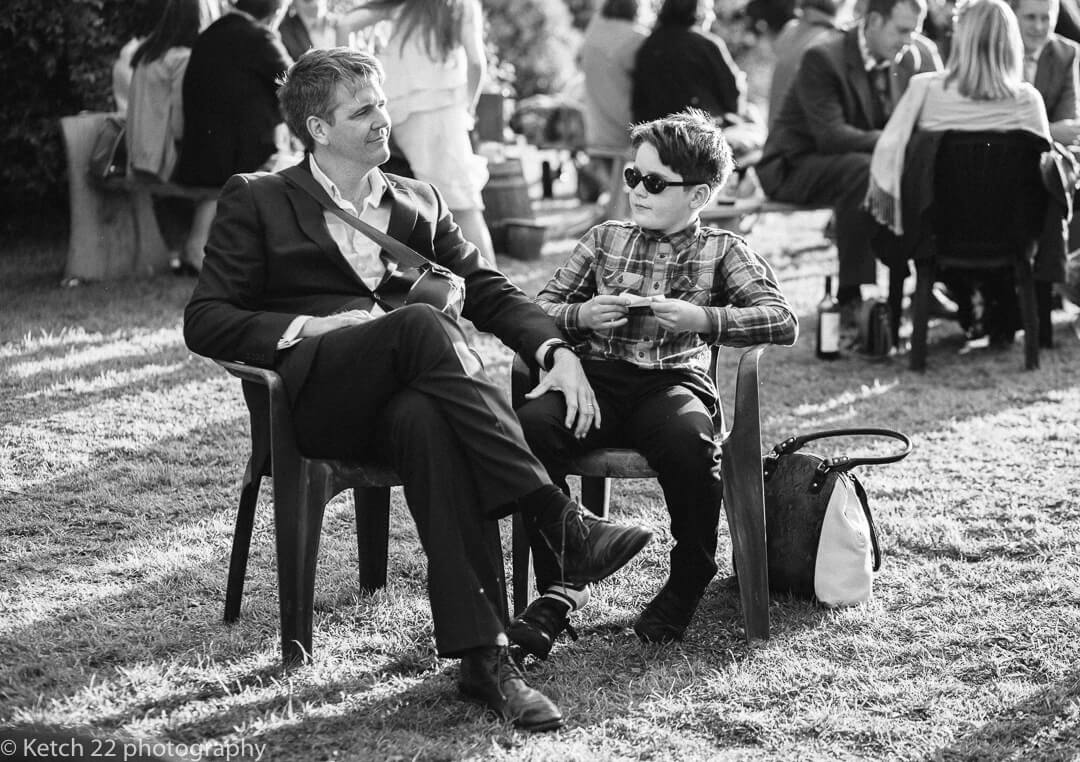 Father and sun relaxing at outdoors vintage wedding