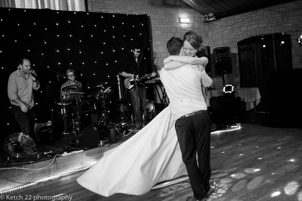 Groom swinging bride at first dance at The Barn at Berkeley wedding in Gloucestershire