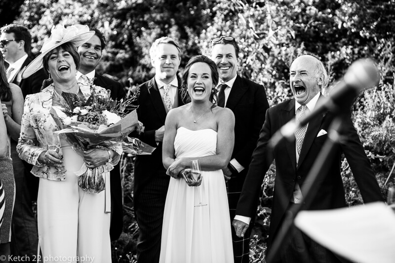 Mum and Dad laughing during speeches at Dorset summer wedding