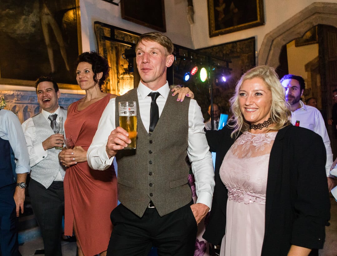 Wedding guests watching bride and groom 