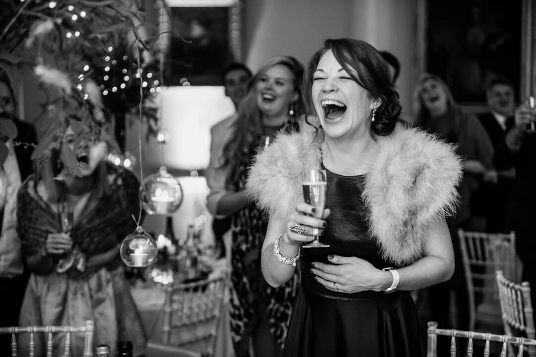 Natural documentary weddings photo of Bridesmaid laughing at speeches