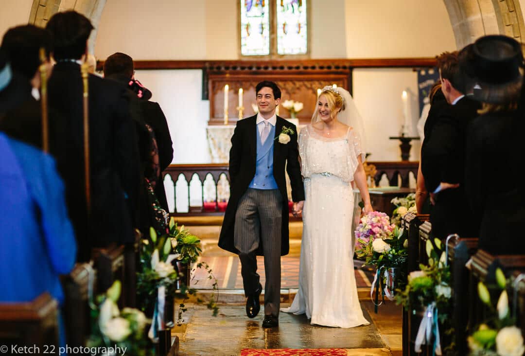 Bride and groom walking down aisle after wedding ceremony