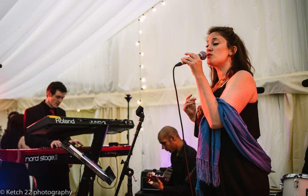 Singer in wedding band performing on stage