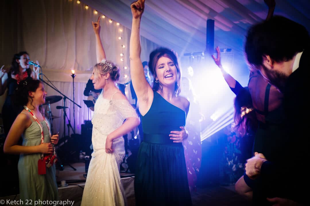 Bride and wedding guests dancing at reception