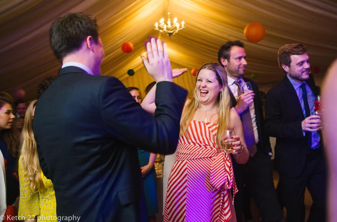 Wedding guests dancing at reception 