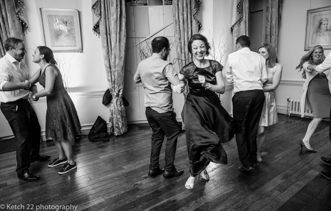 Wedding guests dancing at reception at Country house 