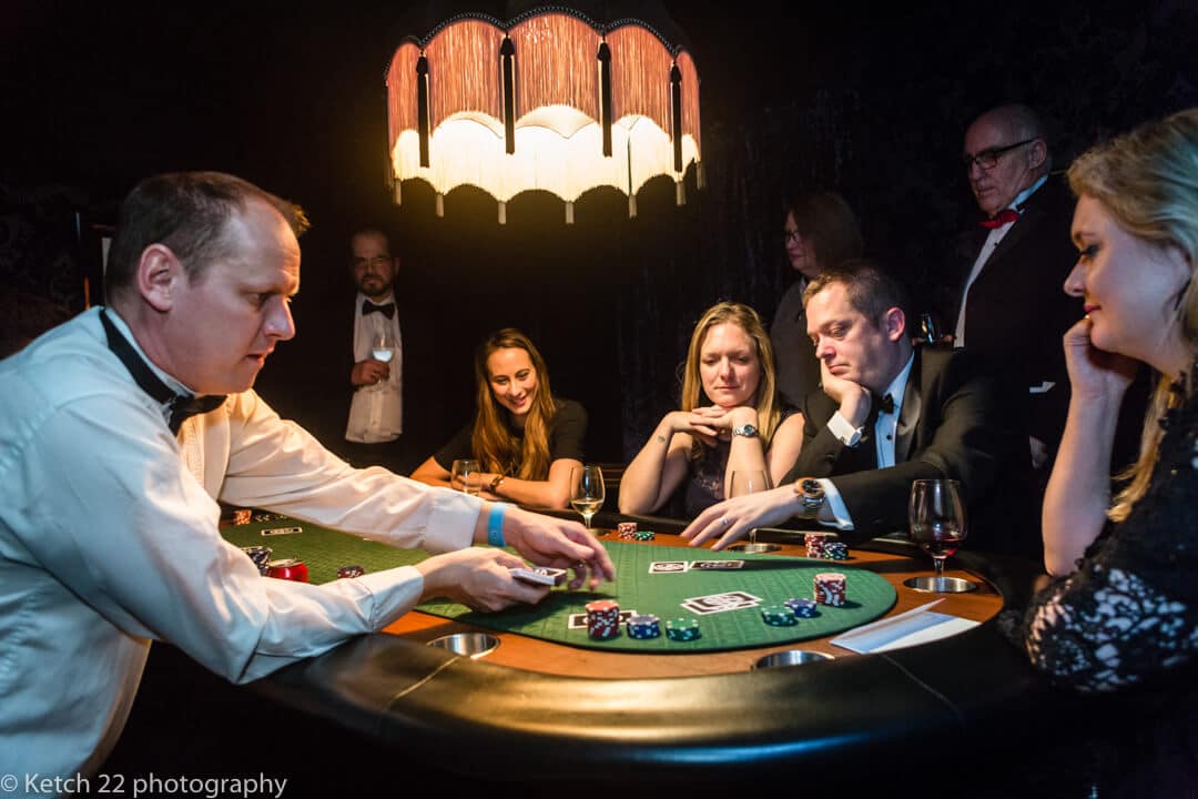 Reportage wedding photography at North Cadbury Court with guests gambling at the casino