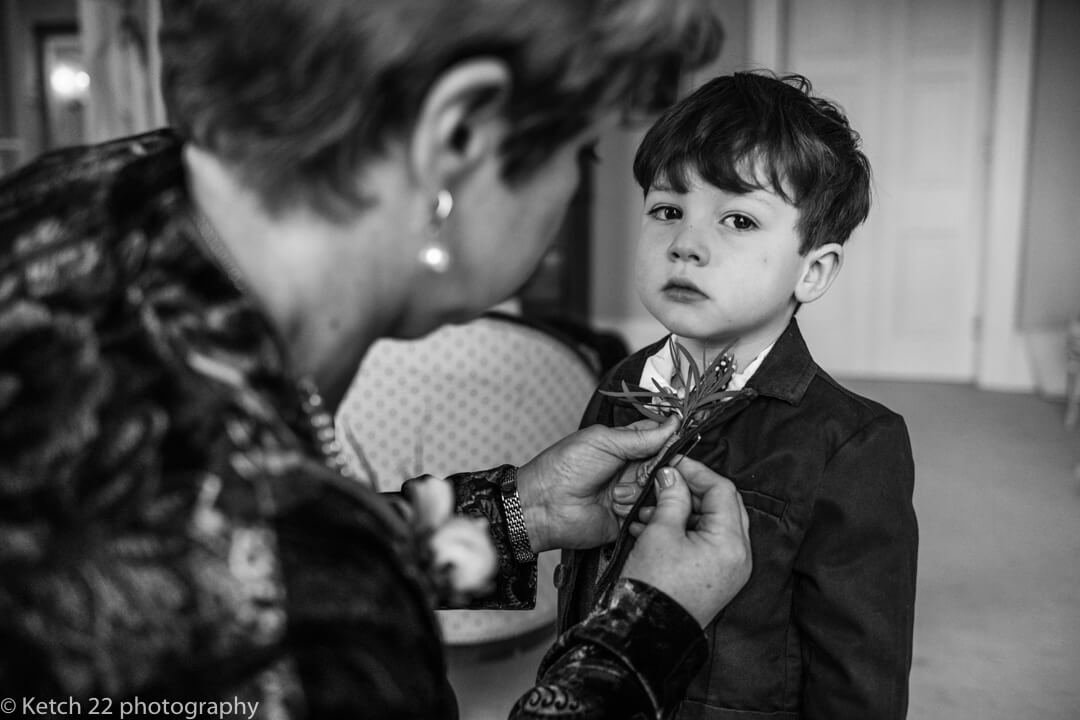 Page boy getting ready at documentary wedding