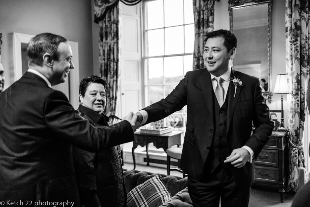 Groom greeting guests at North Cadbury Court wedding