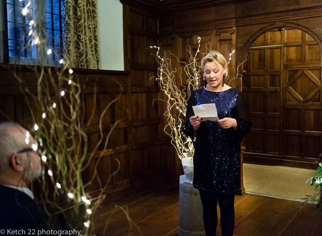 Wedding guest making readings during ceremony