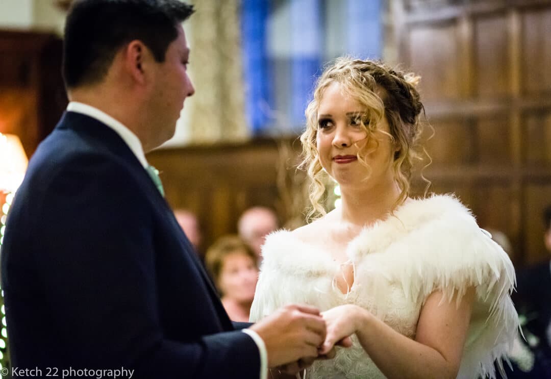 Reportage wedding photography of bride looking at groom during wedding ceremony