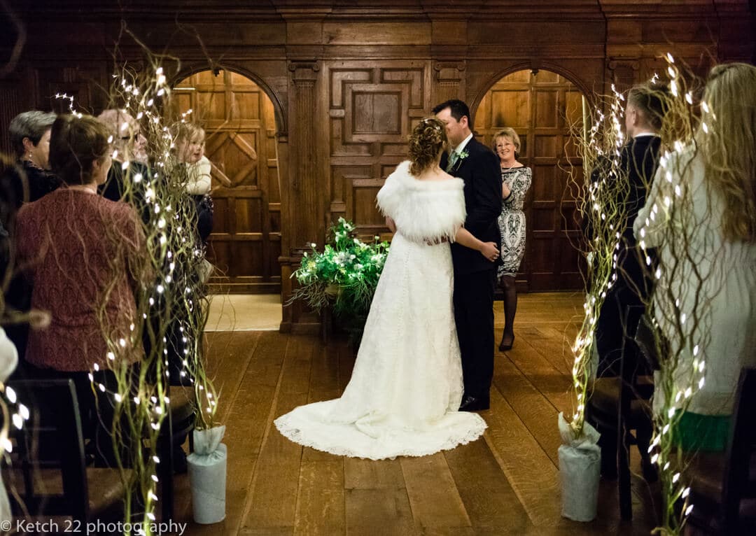 Bride and groom kissing at wedding ceremony