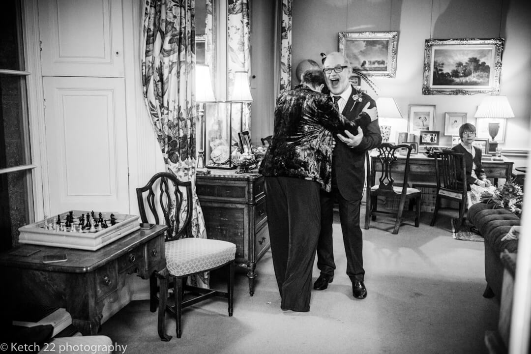 Mother and father of bride hugging eachother at North Cadbury Court wedding