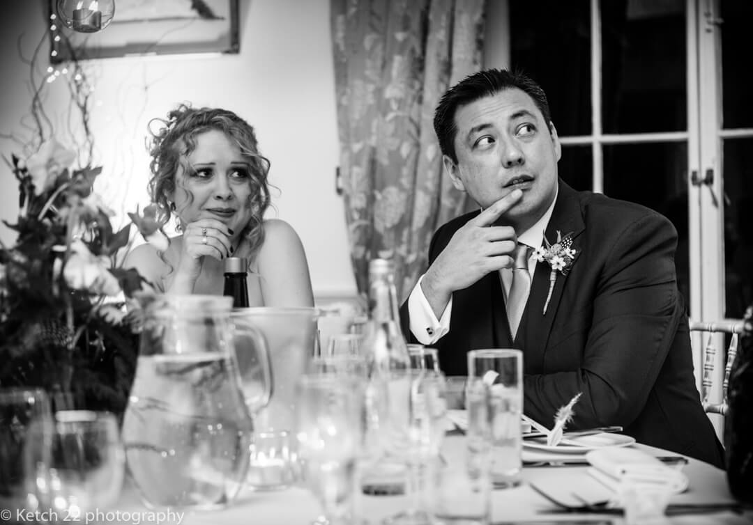 Groom and bride listen to wedding speeches at North Cadbury Court