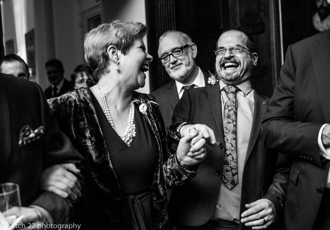 Mother of bride laughing with wedding guest