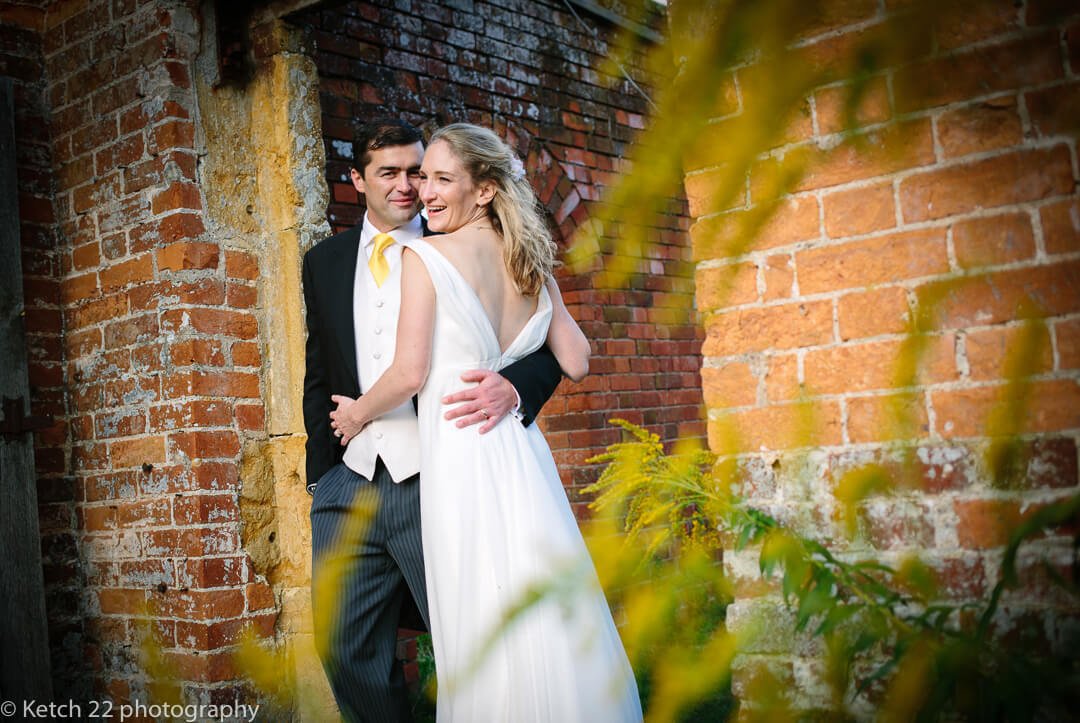 Portrait of bride and groom in garden at summer wedding