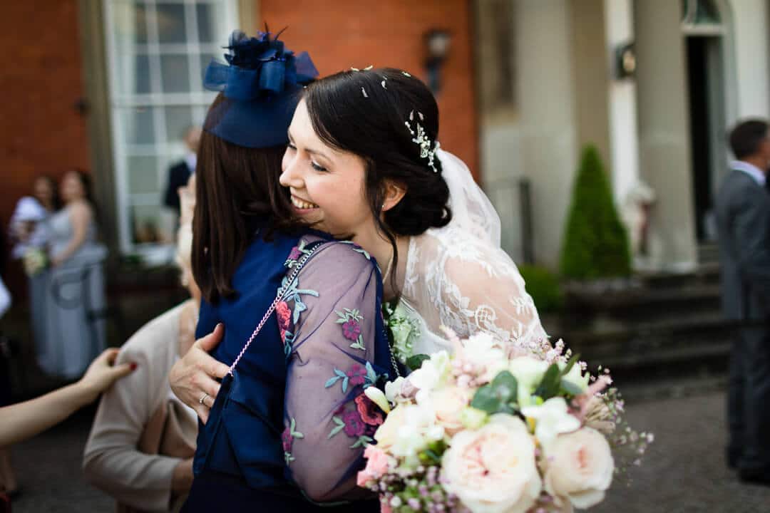 Bride hugging wedding guest