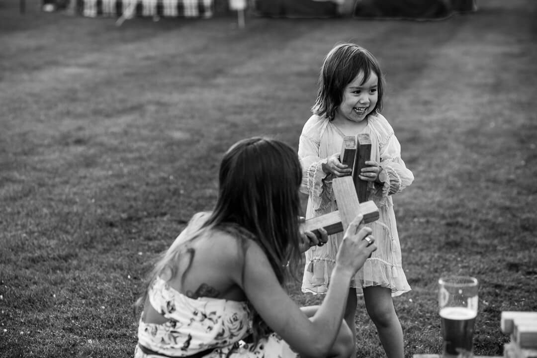 Little girl laughing at summer wedding