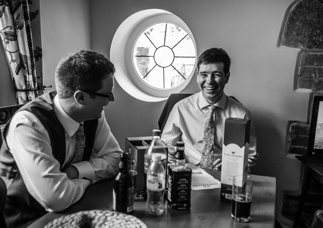 Best man laughing at wedding preparations