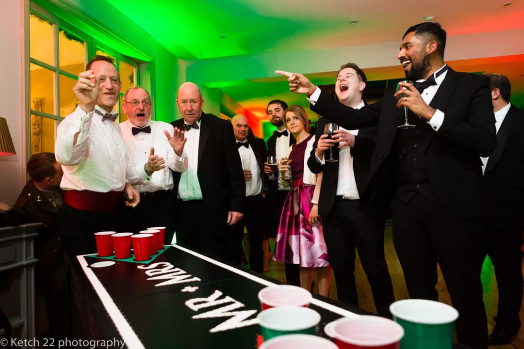 Guests playing ping pong games at The Lake Hotel wedding