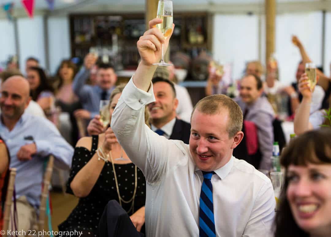 Wedding guests toasting the speeches