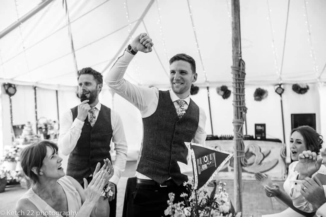 Groom fist pumping the air during wedding speech