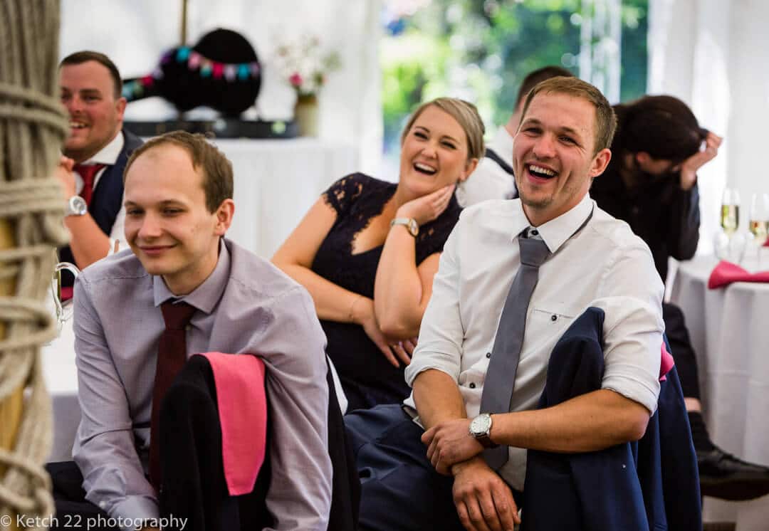 Guests reacting to speeches at Marquee wedding