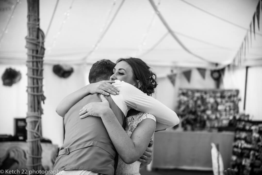 Bride and groom hugging after wedding speeches