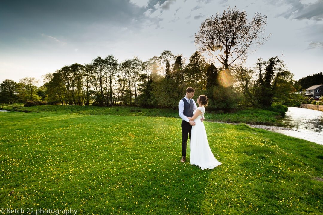 Sunset photo of bride and groom in feild
