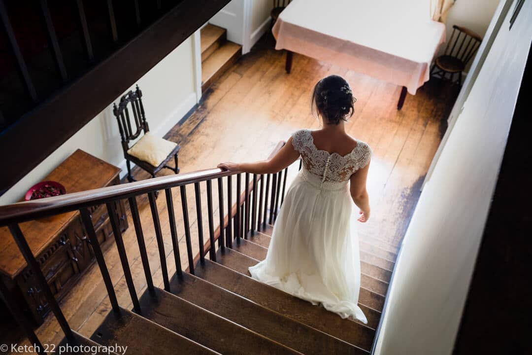 Bride descending stairs at wedding