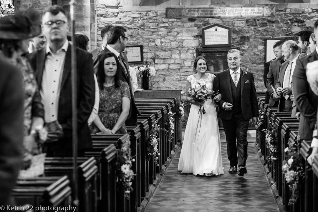 Bride and father entering the church at rural wedding