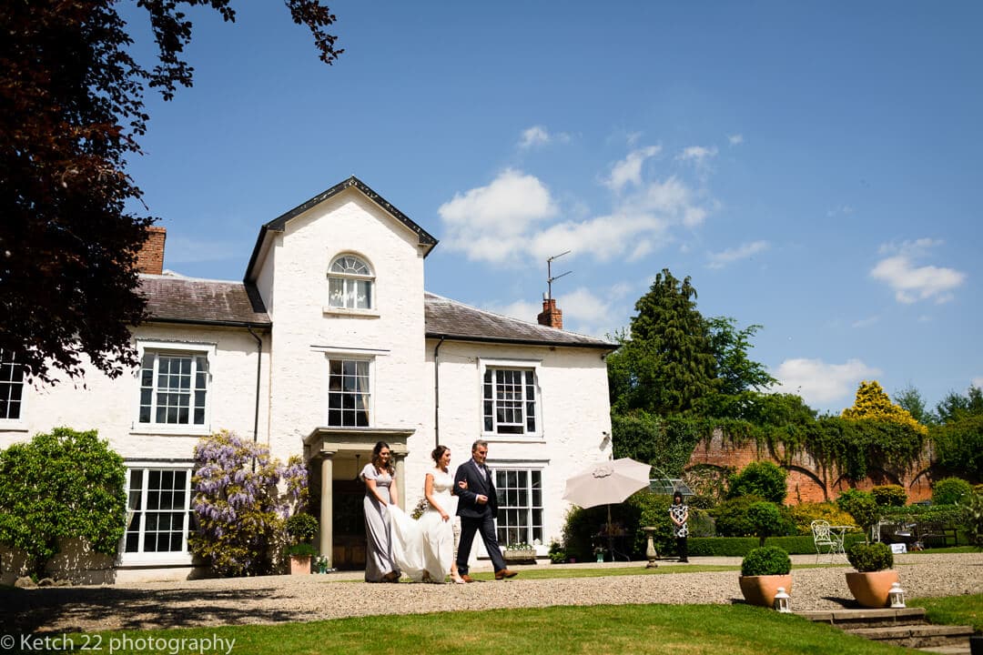 Bride and Dad walking in front of Georgian house