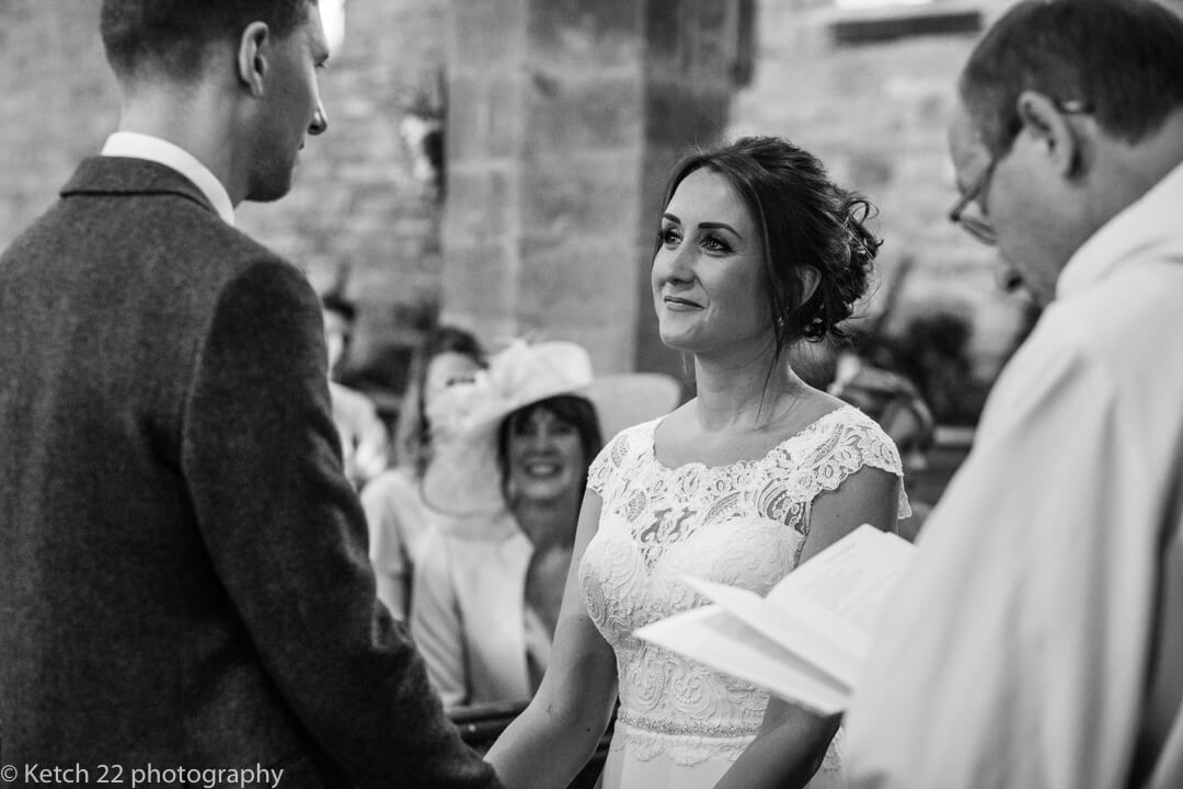 Bride looking into grooms eyes at church wedding ceremony