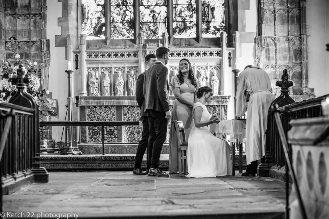 Bride signing the registrar at country church wedding