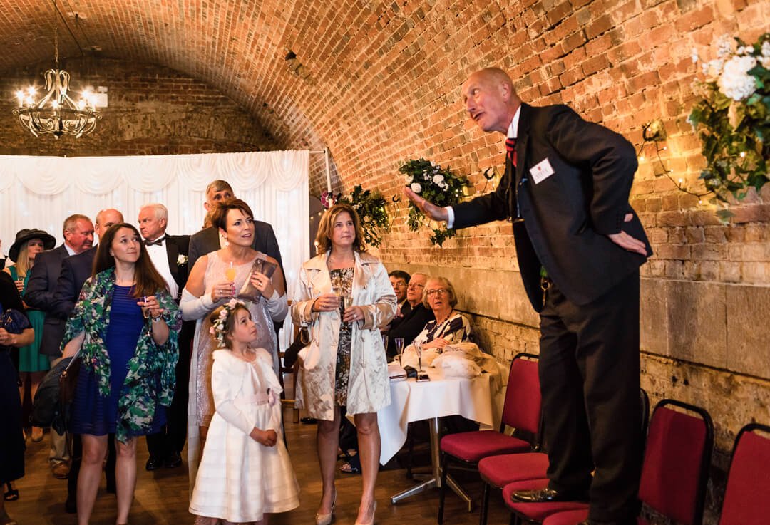 Wedding guests listening to host